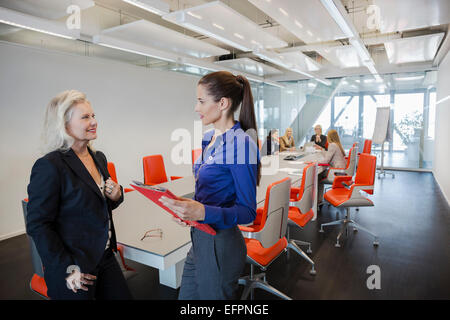 Two women talking in office Stock Photo