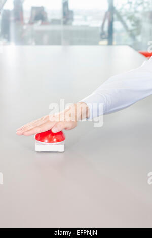 Hand pressing red button Stock Photo