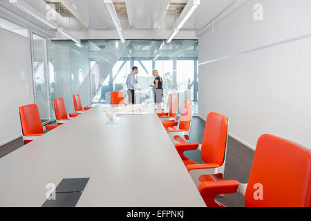 Colleagues standing in conference room Stock Photo