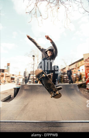 Skateboarding on mini ramp, Frontside nollie heelflip, Berlin, Germany Stock Photo