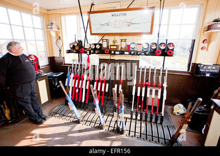 The signalman at Williton station on the West Somerset Railway between trains in his signal box Stock Photo