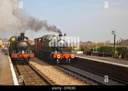 Two Ex GWR loco Nos.1450 & 5553 pass at Williton station on the West Somerset Railway, England  UK Stock Photo