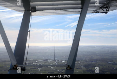aerial view of Emley Moor TV mast under the wing of a light aircraft Stock Photo