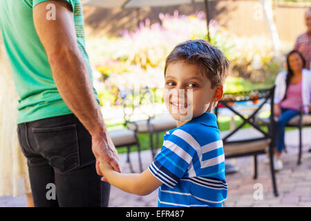 Father with son looking over shoulder Stock Photo