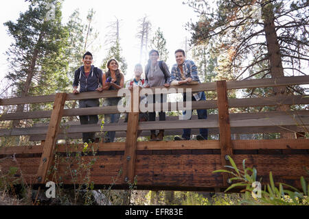 Portrait of five young adult friends on wooden bridge in forest, Los Angeles, California, USA Stock Photo