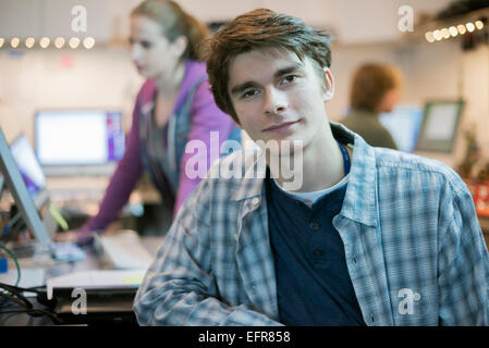 Two people in a computer repair shop. Technicians, young people working to repair computers. Stock Photo