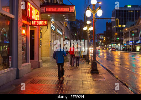 People walking downtown on rainy night-Victoria, British Columbia, Canada. Stock Photo