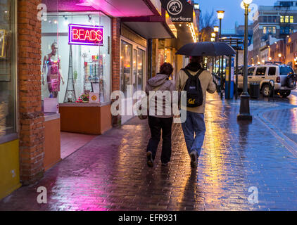 People walking downtown on rainy night-Victoria, British Columbia, Canada. Stock Photo