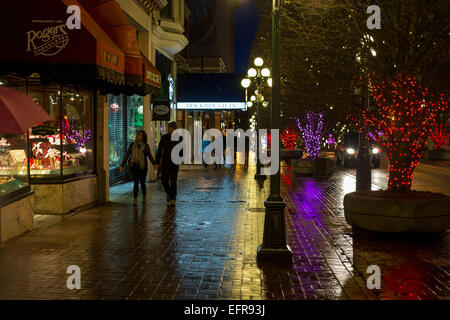 People walking downtown on rainy night-Victoria, British Columbia, Canada. Stock Photo