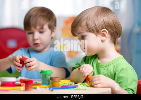 kids with play clay at home Stock Photo