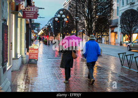 People walking downtown on rainy night-Victoria, British Columbia, Canada. Stock Photo