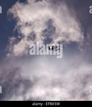 A small floatplane, a seaplane in the air in a sky full of clouds. Stock Photo