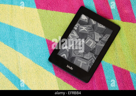 Kindle Paperwhite on a beach towel Stock Photo