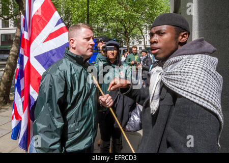 Brustchom Ziamani (R) pictured 9th May 2014 outside the Indian High Commission in London being confronted by Paul Golding (L) of Britain First Nationalist movement.  Brustholm Ziamani, 19, has been remanded in custody after appearing in court to face terror allegations. Ziamani, of Camberwell, south-east London, has been accused of 'engaging in conduct in preparation of terrorist acts' on or before 19th August 2014. Mr Ziamani was arrested in east London on Tuesday 19th Aug 2014. He is currently on trial at Old Bailey court. Stock Photo