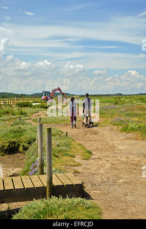 Young Family walking along trail in North Norfolk UK Stock Photo