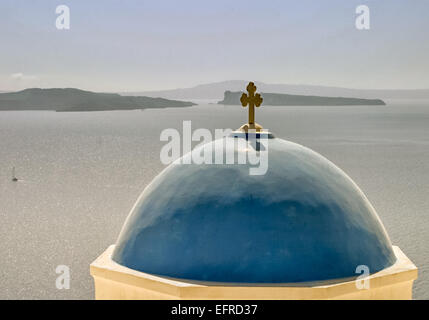 Santorini, Greece. 29th Sep, 2004. A traditional blue-domed Greek Orthodox Church overlooks the lagoon of the caldera (volcanic crater) in Santorini. In distance are the volcanic islands Nea Kameni, Palea Kameni and Thirassia. The southernmost member of the Cyclades island group, colorful Santorini is a favorite tourist and cruise ship destination. © Arnold Drapkin/ZUMA Wire/Alamy Live News Stock Photo