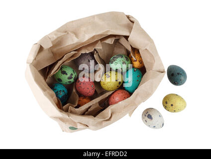 Colored quail eggs in a package of brown paper on white background. Isolated with clipping path. Top view. Stock Photo