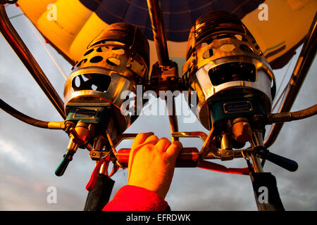 Low angle view of pilot inflating hot air balloon with gas burners, close up Stock Photo