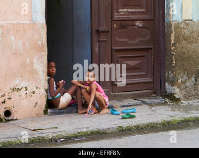 Kids playing in door way, Cuba Stock Photo