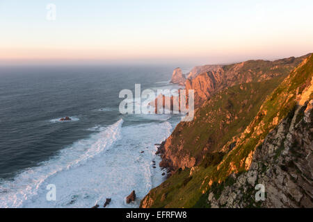 Cabo da Roca (Cape Roca) at sunset, is a cape which forms the westernmost extent of mainland Portugal and continental Europe Stock Photo