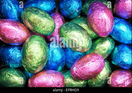Colorful wrapped Easter egg chocolates background Stock Photo