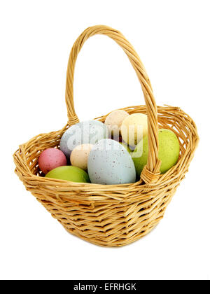 Easter basket filled with colored eggs isolated on white Stock Photo