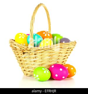 Easter basket filled with colorful eggs over a white background Stock Photo