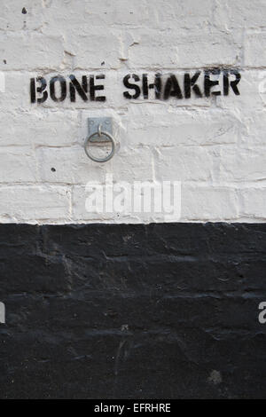 Bone Shaker, bicycle lock on a pub wall, Cambridge, UK Stock Photo