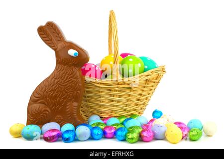Chocolate bunny and candy with Easter basket over white Stock Photo