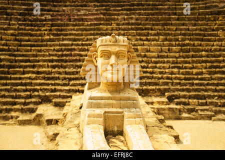 sphinx model close-up with pyramid background Stock Photo