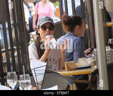 Miranda Cosgrove wearing a t-shirt with the logo 'Always and Forever'  stops for lunch and drinks from a bottle of water before shopping at The Grove in Hollywood  Featuring: Miranda Cosgrove Where: Los Angeles, California, United States When: 07 Aug 2014 Stock Photo