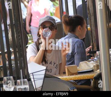 Miranda Cosgrove wearing a t-shirt with the logo 'Always and Forever'  stops for lunch and drinks from a bottle of water before shopping at The Grove in Hollywood  Featuring: Miranda Cosgrove Where: Los Angeles, California, United States When: 07 Aug 2014 Stock Photo