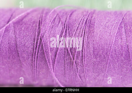 Sewing strings on a light background, macro shot, local focus Stock Photo