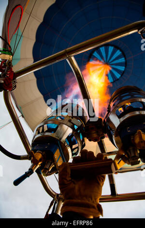 Low angle view of pilot inflating hot air balloon with gas burner, close up Stock Photo