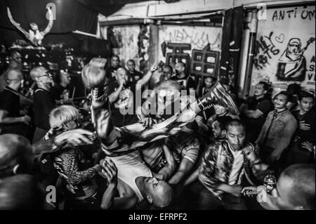 Malaysian Skin heads crowd surfing at punk gig at Rumah Api live music venue in Kuala Lumpur, Stock Photo