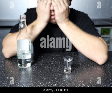alcohol abuse - drunk man with vodka Stock Photo