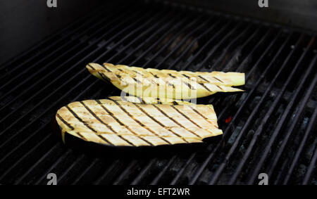 Chopping the roasted eggplant in preparation of an Eggplant salad. Stock Photo