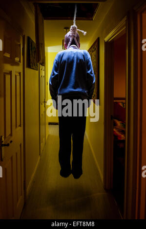 A boy hangs by a noose in a suicide attempt Stock Photo
