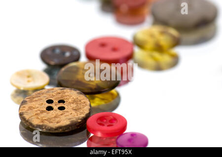 Close up of multi-coloured buttons on reflective surface Stock Photo
