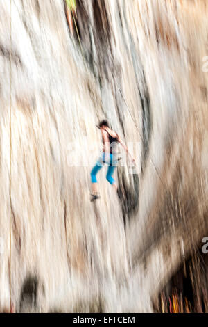 Motion blurred rock climber falling down. Stock Photo