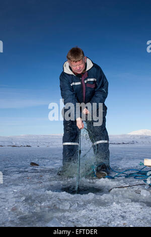 Ice fishing for arctic char on Lake Thingvellir, Thingvellir National Park, Iceland Stock Photo