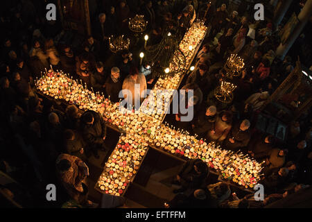 Bulgarian Orthodox Church celebrates the feast of the Holy Hieromartyr Haralambos, who is also worshipped as patron of all beekeepers. Thousands of honey jars and burning candles are arranged in the form of the Holy Cross in the church of the Presentation of the Blessed Virgin in Blagoevgrad, Bulgaria. Honey is consecrated during the Divine Liturgy and it is believed it becomes magical and healing. © Hristo Vladev/Pacific Press/Alamy Live News Stock Photo