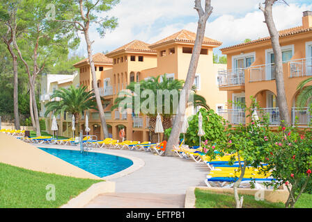 Portrait of tropical apartment building with trees. Stock Photo