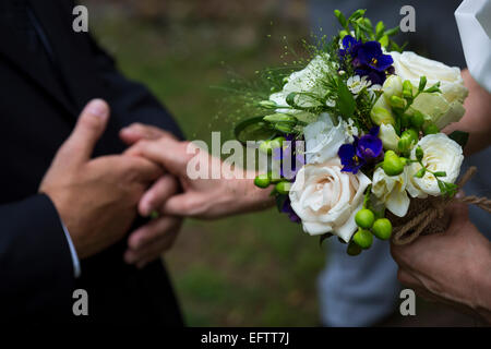 Newlyweds holding hands during the wedding ceremony Stock Photo