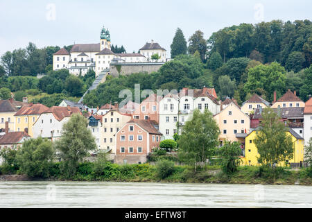 Waterfron of the citiy of Passau at the river Inn. Pilgrimage church Mariahilf on top of the hill. Stock Photo