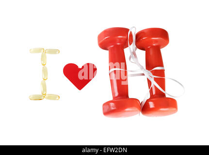 I love fitness. Still life with a heart and dumbbells tied with satin ribbon on white background. Isolated with clipping path. T Stock Photo