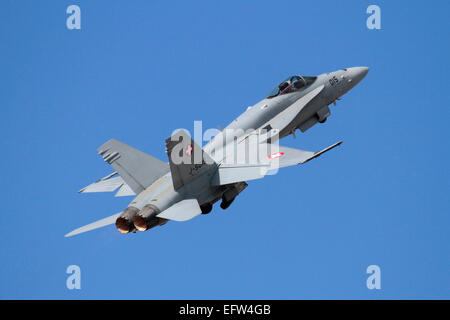 Swiss Air Force F-18 Hornet fighter jet aircraft taking off against a clear blue sky. Military aviation. Stock Photo