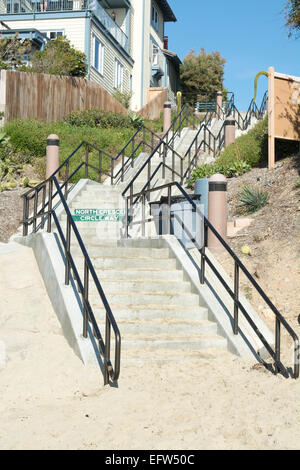 A long stairway leads from the beach cove up to the main street in a Laguna Beach California oceanfront getaway. Stock Photo