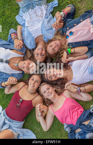 happy teen girls in circle  holding hands and smiling Stock Photo