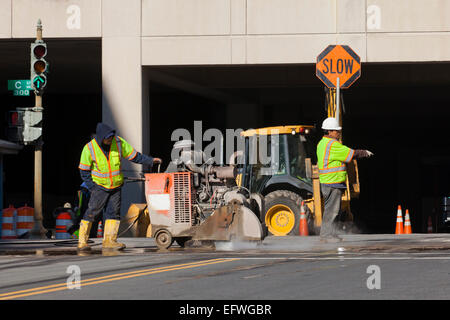 Municipal construction worker with stop sign on site - USA Stock Photo